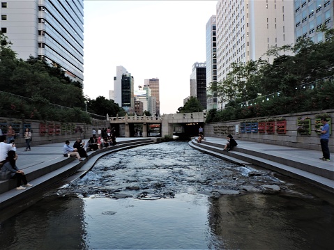 Seoul, Korea. Downtown,Cheonggye stream - May 30 2018: people enjoy the nice summer evening at public recreation space around the beautiful water stream.