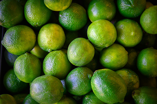 A view of colorful, ripe limes, from directly above.