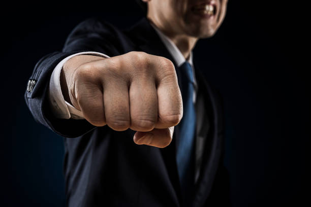 istock Businessman sticking out fist 1180905369