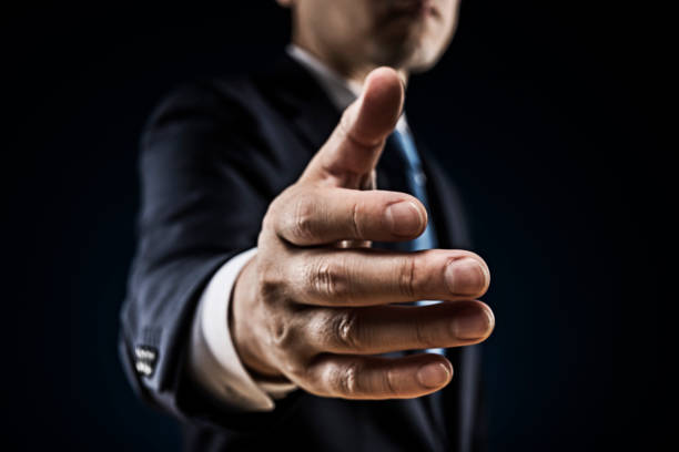 istock Businessman in suit offer a handshake 1180905461