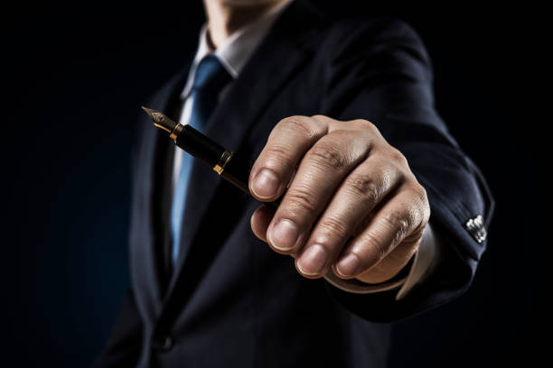 istock Businessman with a fountain pen 1180905467