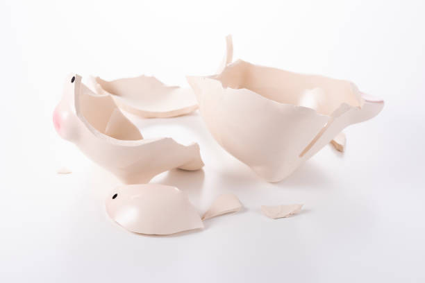 istock Cracked piggy bank on white background 1180907430