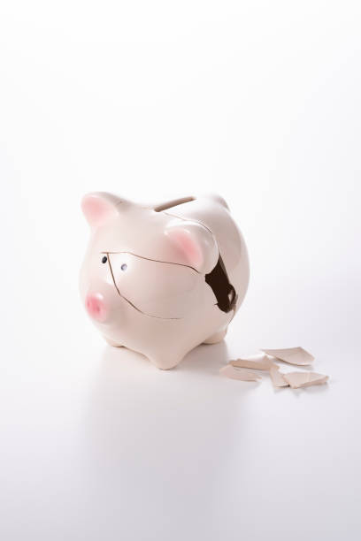 istock Cracked piggy bank on white background 1180907541