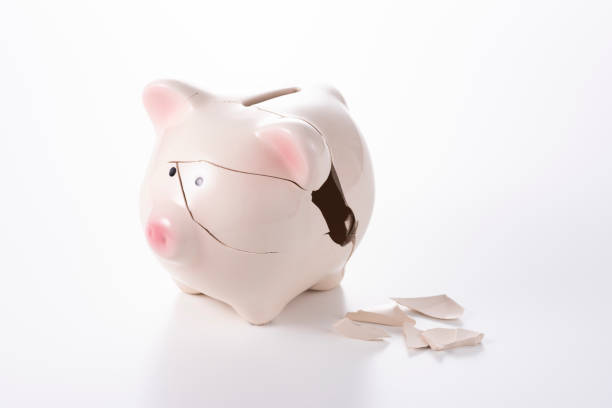 istock Cracked piggy bank on white background 1180907574