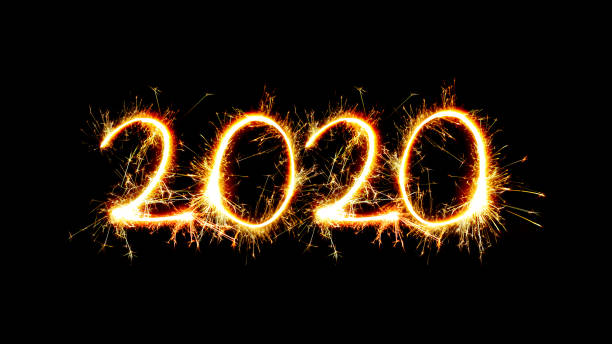 istock Number 2020 written sparkling sparklers isolated on black background With Copy Space For Text.Happy New Year 2020 1180909444