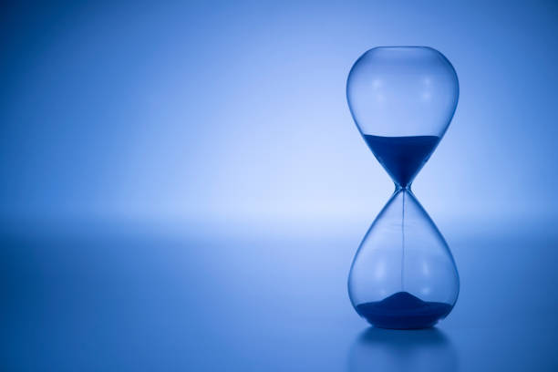 Retro glass hourglass close up.