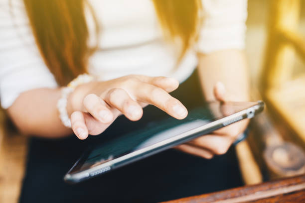 istock Business women using smart tablet computer close up on hand 1180910416