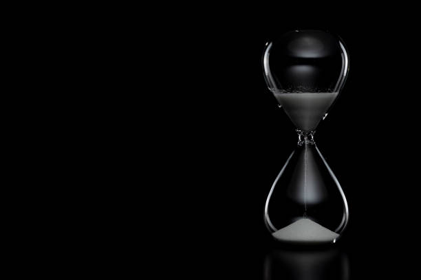 Close up of hourglass on black background. Close up of hourglass on black background. timer photos stock pictures, royalty-free photos & images