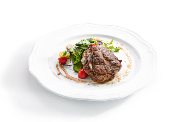 istock Pork Neck Steak with Mixed Salad on White Restaurent Plate 1180912384