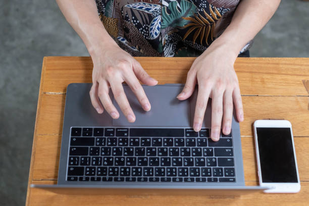 istock Close up of business man hands typing on laptop computer 1180912390