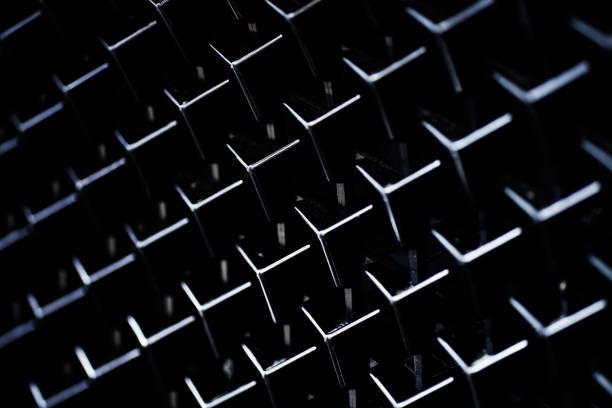 A macro of a window screen that is wet with water from rain in some spots.
