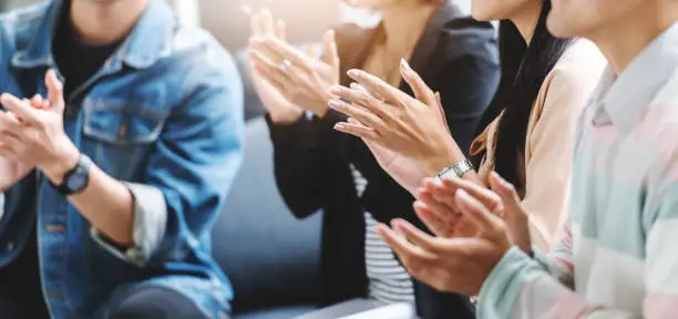 Photo of Business people applauding.