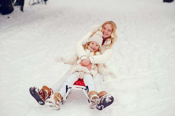 istock Mother and daughter in a winter park 1180920446