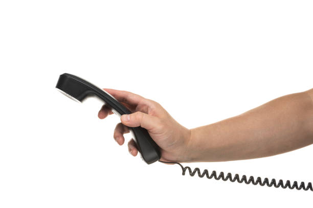 istock Male hand holding a handset on white background 1180921810