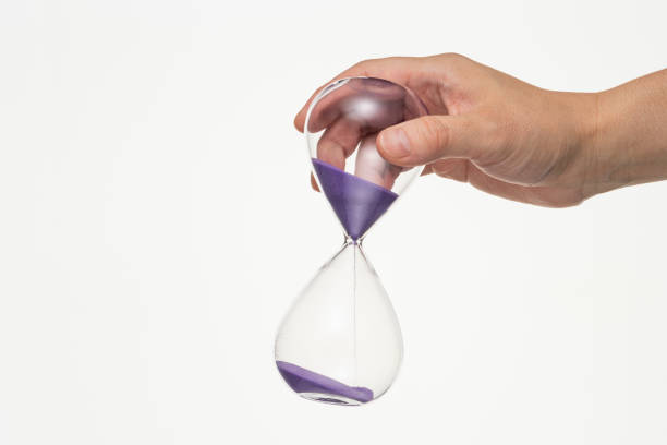 istock Male hand with hourglass on white background. 1180921934