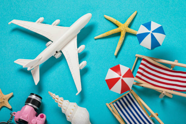 istock Various leisure accessories on a blue background, top view. On vacation by plane 1180921945