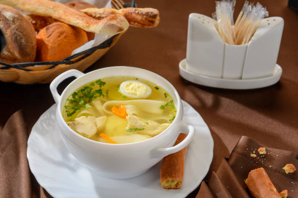 istock A plate of chicken soup with egg and herbs. 1180924935