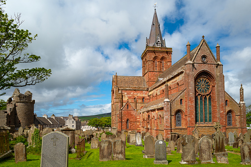 Kirkwall, Orkney, Scoland - June 4,  2019:  The apse of the St.Magnus Presbyterian Cathedral seen from the cemetery
