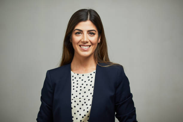 Front view of a woman wearing a suit and smiling. Studio headshot on white background. Spanish model. headshot stock pictures, royalty-free photos & images