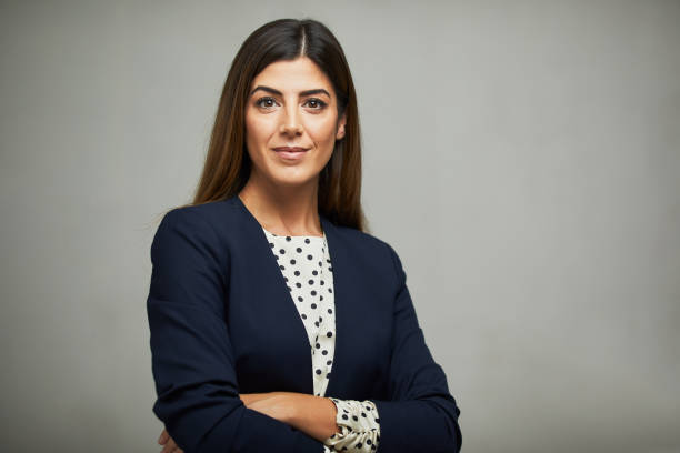 Studio waist up portrait of a beautiful businesswoman with crossed arms. Studio headshot on white background. Spanish model. 30 34 years stock pictures, royalty-free photos & images