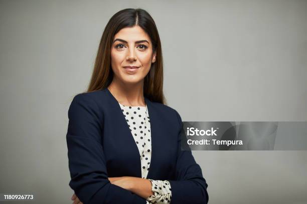 Studio Waist Up Portrait Of A Beautiful Businesswoman With Crossed Arms Stock Photo - Download Image Now