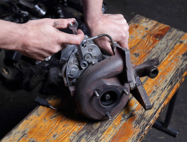 istock Car service - Engine repair mechanic hands with wrench Centrifugal  compressor nut 1180929004