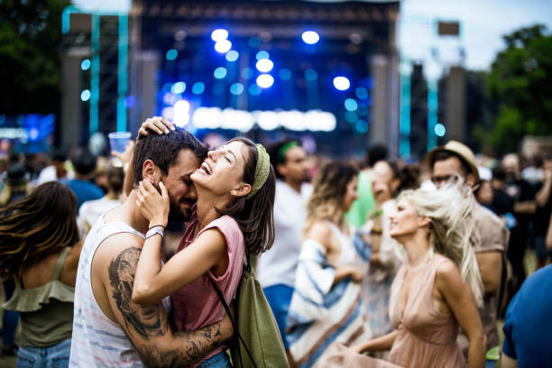 istock Happy embraced couple having fun on music concert. 1180930164