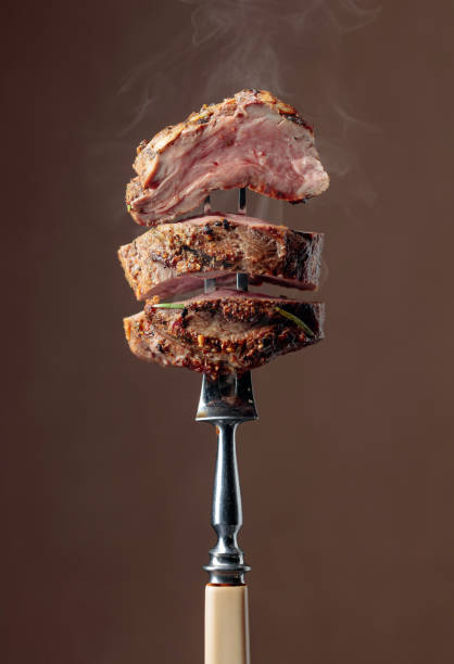 istock Grilled ribeye beef steak with rosemary on a brown background. 1180930291