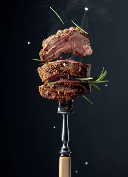 istock Grilled ribeye beef steak with rosemary on a black background. 1180930297