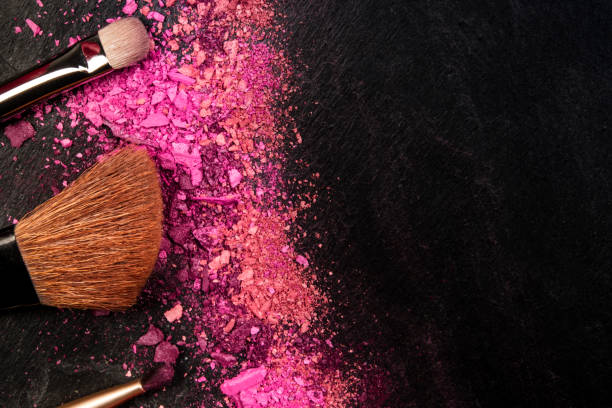 istock Make-up brushes and crushed cosmetics, shot from above on a black background with a place for text, a beauty design template for a makeup banner 1180930428