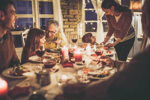 istock Happy multi-generation family enjoying during dinner at home. 1180931245