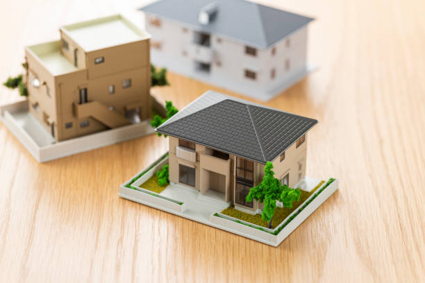 House model on wooden table House model on wooden table detached house stock pictures, royalty-free photos & images