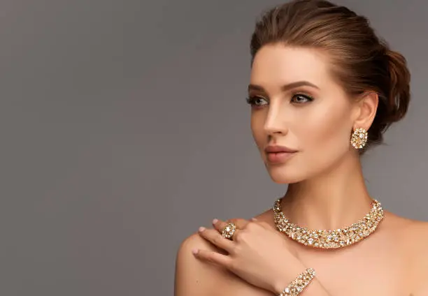 Photo of Alluring woman dressed in a posh jewelry set of necklace, ring and earrings. Elegant evening style.