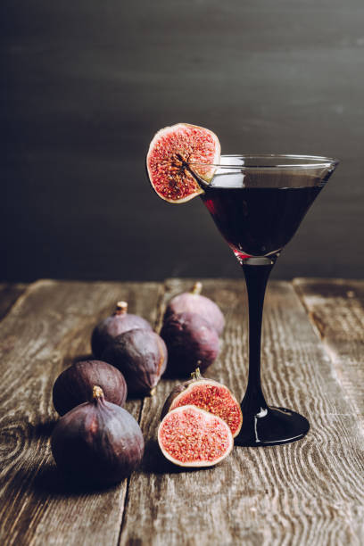 istock Martini cocktail with black vodka and figs on the rustic background 1180931525