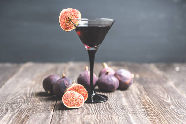 istock Martini cocktail with black vodka and figs on the rustic background 1180931530