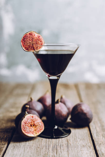 istock Martini cocktail with black vodka and figs on the rustic background 1180931570