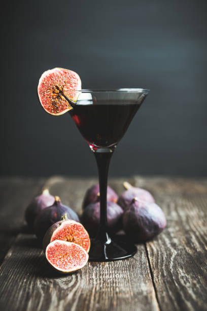 istock Martini cocktail with black vodka and figs on the rustic background 1180931571