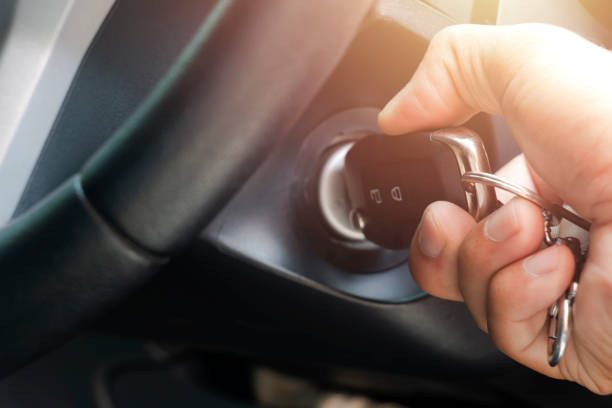 istock Close-up Of Person's Hand Inserting Key To Start Car 1180931589