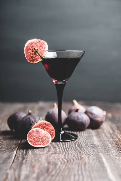 istock Martini cocktail with black vodka and figs on the rustic background 1180931742