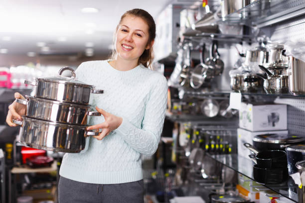istock Glad female is buying new saucepan 1180932677