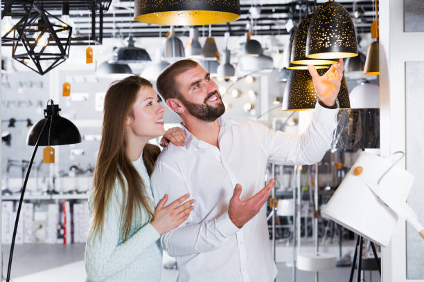 istock couple choosing  suspension lamp 1180933193