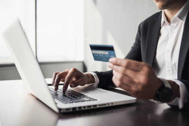 istock Businessman using laptop with credit card in office 1180933931