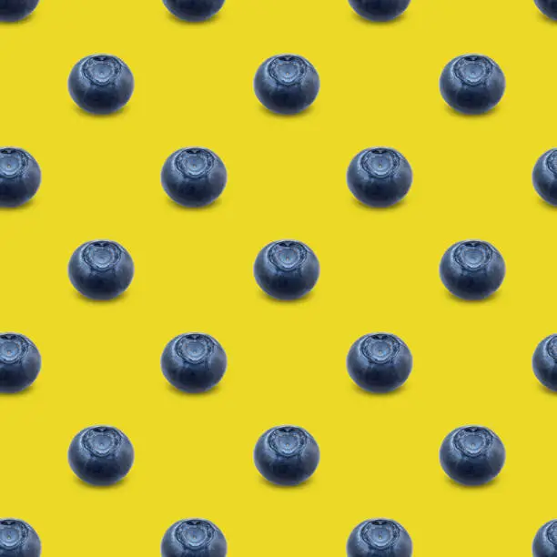 Seamless pattern with blueberries on a yellow background. Modern style isometric concept.Flat lay, top view.