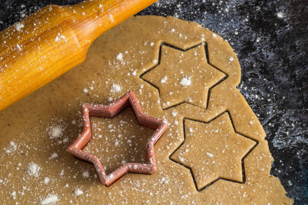istock Cooking Christmas gingerbread cookies with rolling pin on a dark background 1180941876