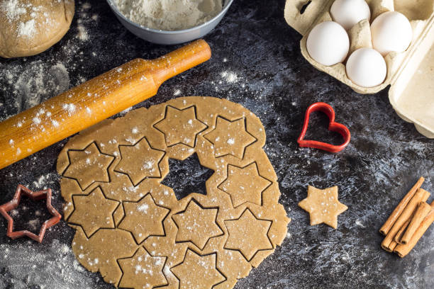 istock Cooking Christmas gingerbread cookies with ingredients on a dark background 1180941902
