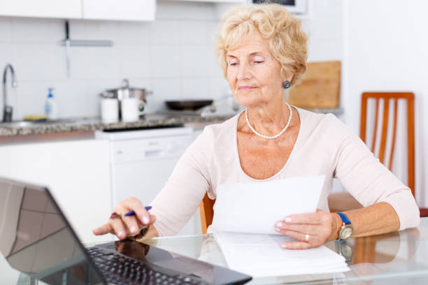 istock Woman filling up documents 1180941956