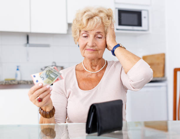 istock Woman holding purse with money 1180941969