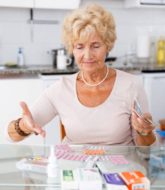 istock Woman counting her expenditure on pills 1180941981