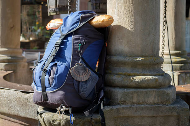 istock Blue daypack of a pilgrim with baguette and scallop 1180942160
