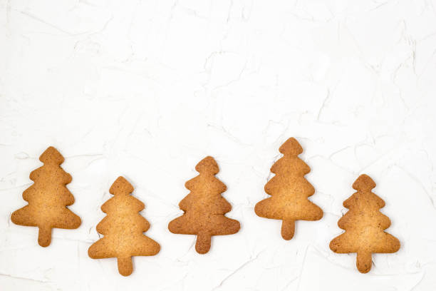 five christmas homemade gingerbread cookies on the white background with copyspace